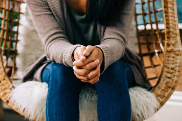 woman sitting in a chair considering what does abba really mean?